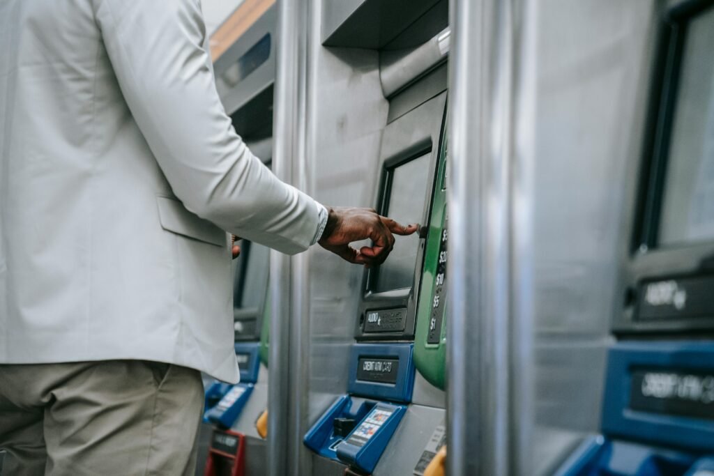 pexels-photo-8555257-8555257 Side view of an adult using a self-service ticket machine indoors.